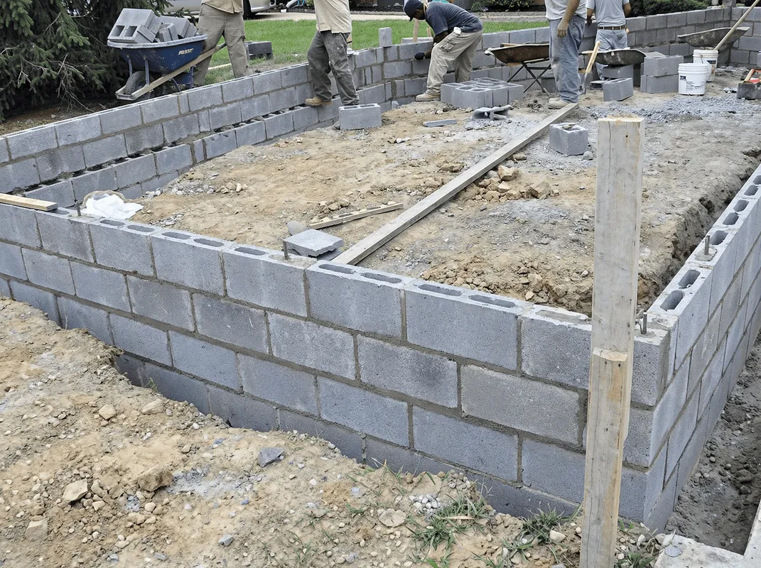 Professionals building a foundation with blocks in Peoria, IL